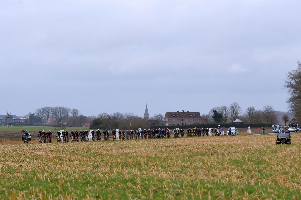 NOKERE BELGIUM MARCH 17 The peloton during the 75th Nokere Koerse Danilith Classic 2021 Mens Elite a 1955km race from Deinze to Nokere Rain Landscape NokereKoerse on March 17 2021 in Nokere Belgium Photo by Luc ClaessenGetty Images
