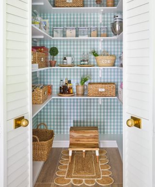 kitchen renovation rules, kitchen pantry with blue and white check wallpaper, white open shelving, baskets, cooking ingredients, rug on floor, double doors open
