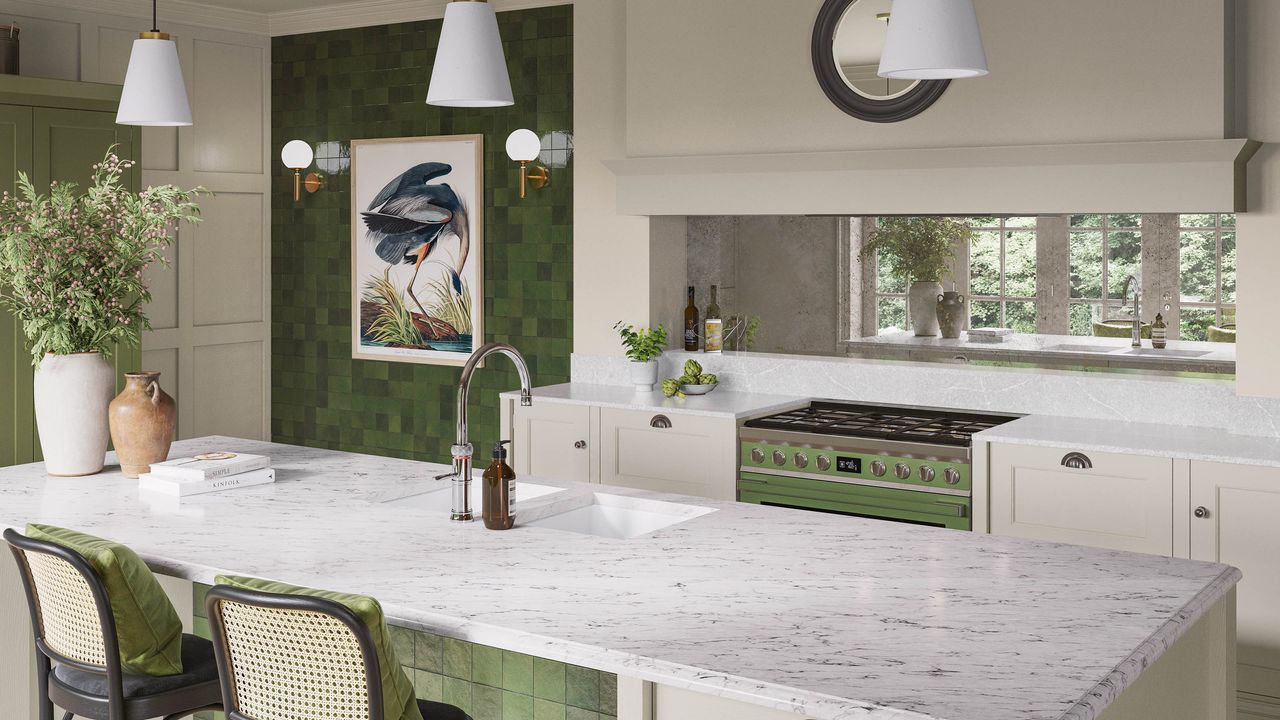 Green kitchen with marble counters and a mirrored splashback.