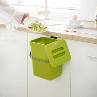 kitchen room with green food caddy on kitchen cabinet