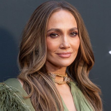 Jennifer Lopez traded wide-leg work trousers for a green cut-out-heavy dress