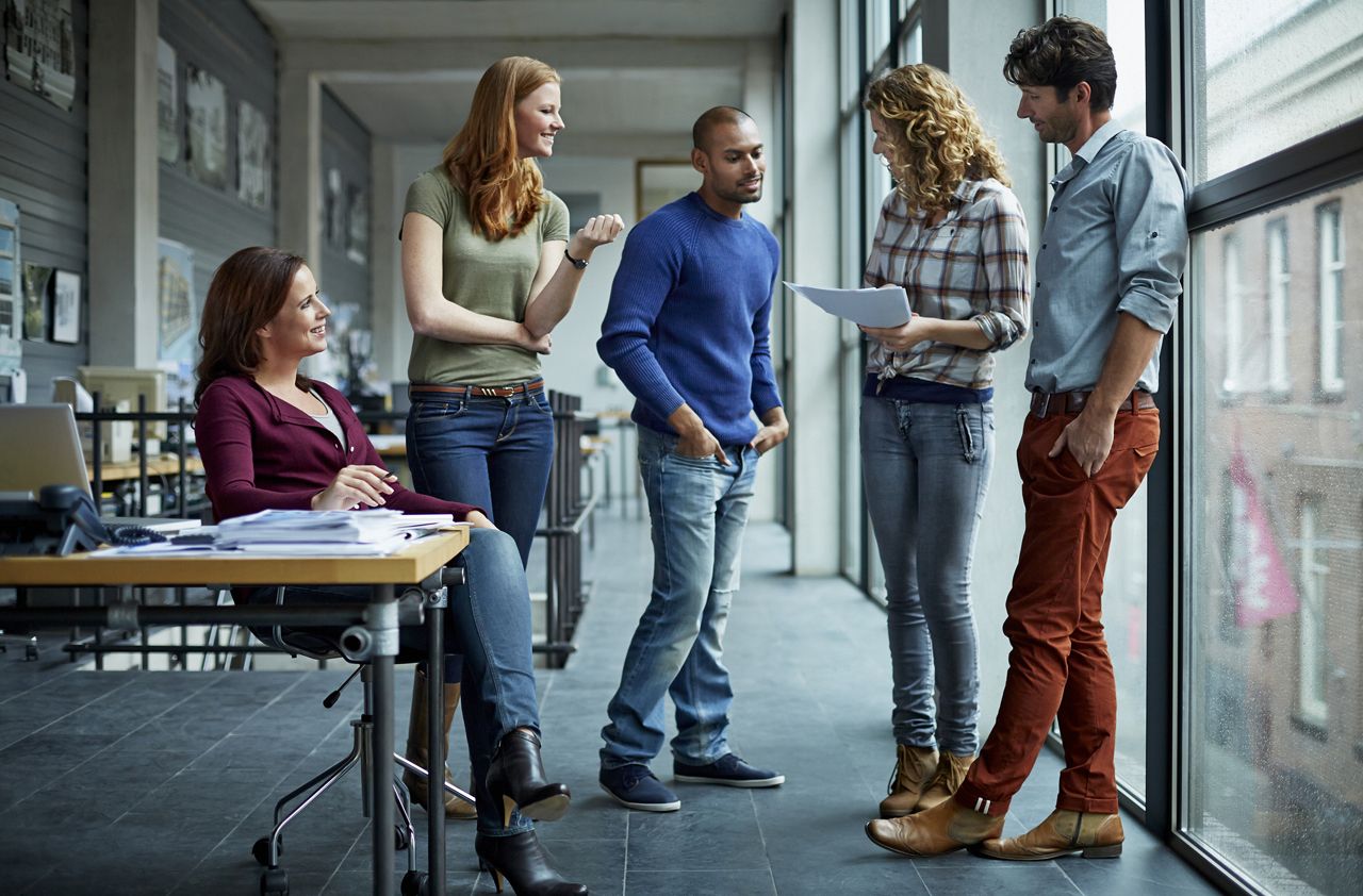 Casual discussion between coworkers in modern architect studio