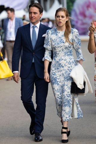 Princess Beatrice and her husband, Edoardo Mapelli Mozzi are given a tour during a visit to The Chelsea Flower Show 2022 at the Royal Hospital Chelsea on May 23, 2022 in London, England. The Chelsea Flower Show returns to its usual place in the horticultural calendar after being cancelled in 2020 and postponed in 2021 due to the Covid pandemic. This year sees the Show celebrate the Queen's Platinum Jubilee and also a theme of calm and mindfulness running through the garden designs.