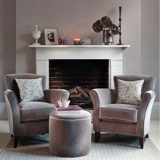 White and grey living room ideas with two grey armchairs and fireplace