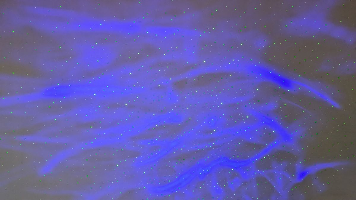 YgiTK Northern Galaxy Lights Projector during Review, on a wooden table against a dark coloured wall