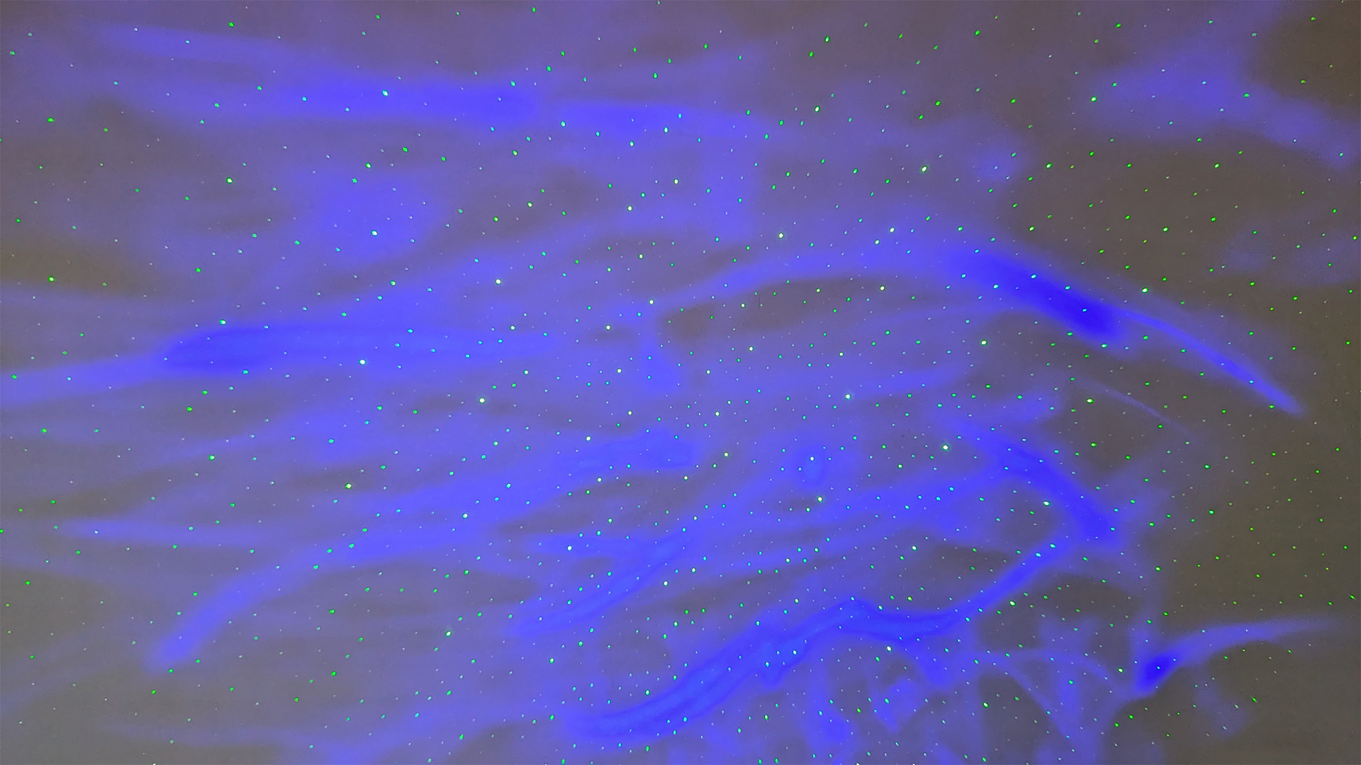 YgiTK Northern Galaxy Lights Projector during Review, on a wooden table against a dark coloured wall