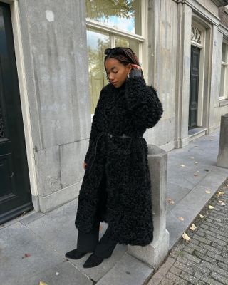 Influencer wears a fluffy coat with a belt.