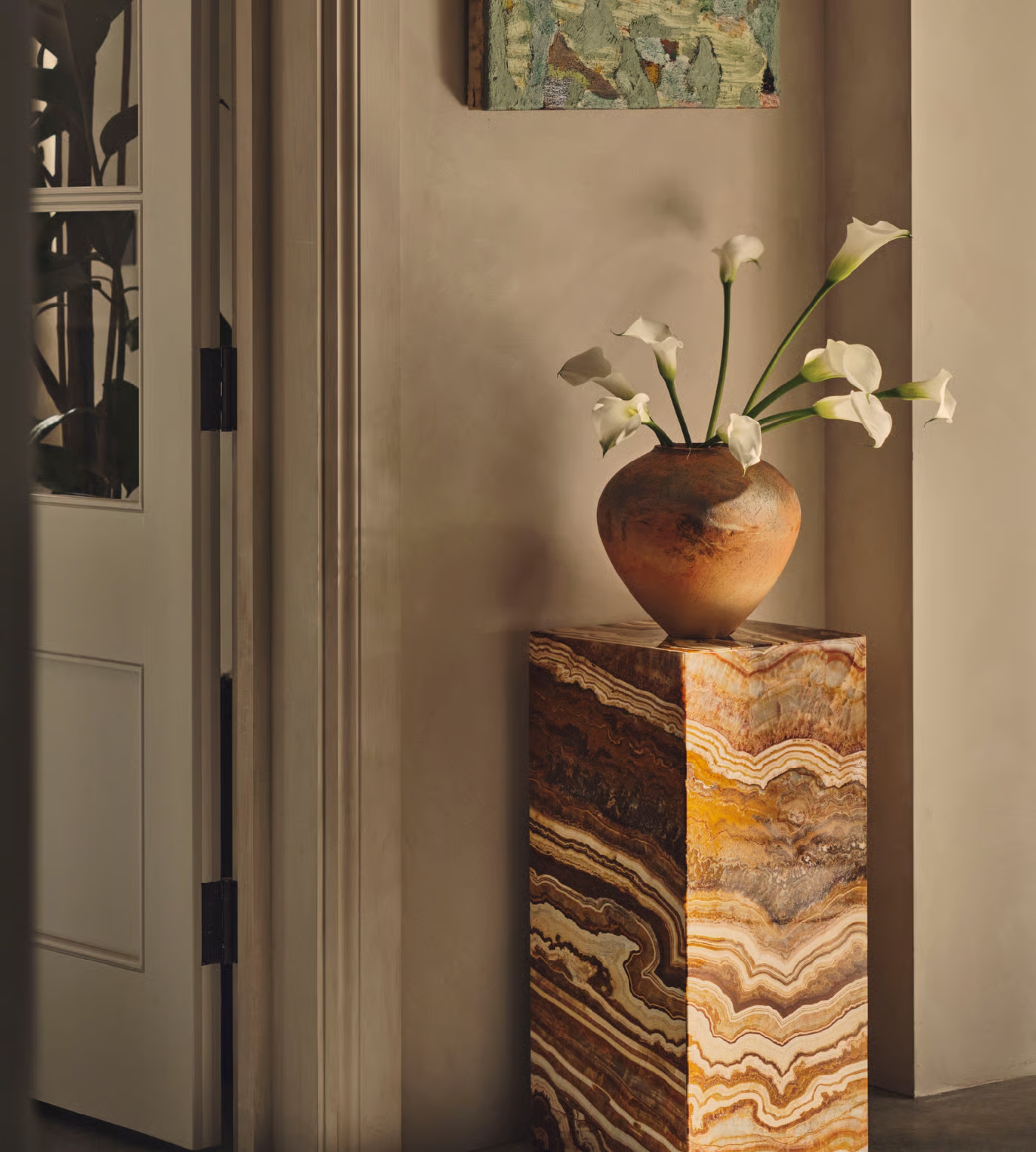 a decorative natural stone plinth with flowers in
