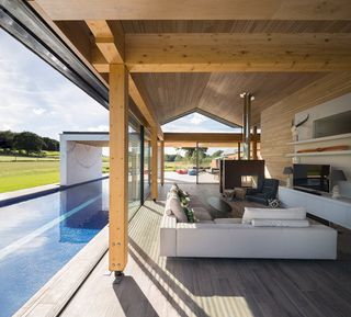 Outdoor patio with concrete pool, wooden beams and ceiling