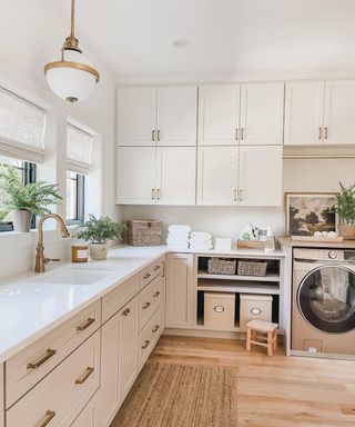 A mudroom laundry area with off-white decor, pendant light, and Samsung washing machine