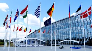A shot of the NATO headquarters surrounded by European flags