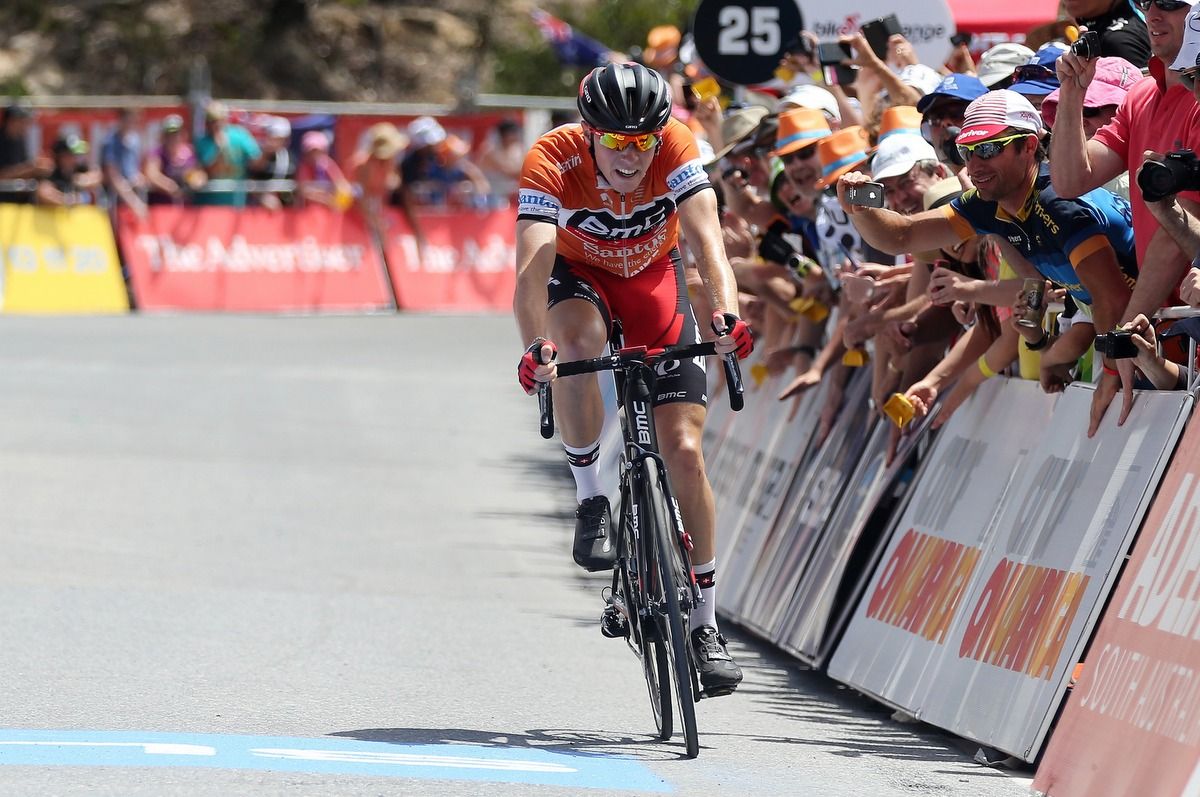 Rohan Dennis crosses the line atop Willunga Hill to hold onto the ochre jersey