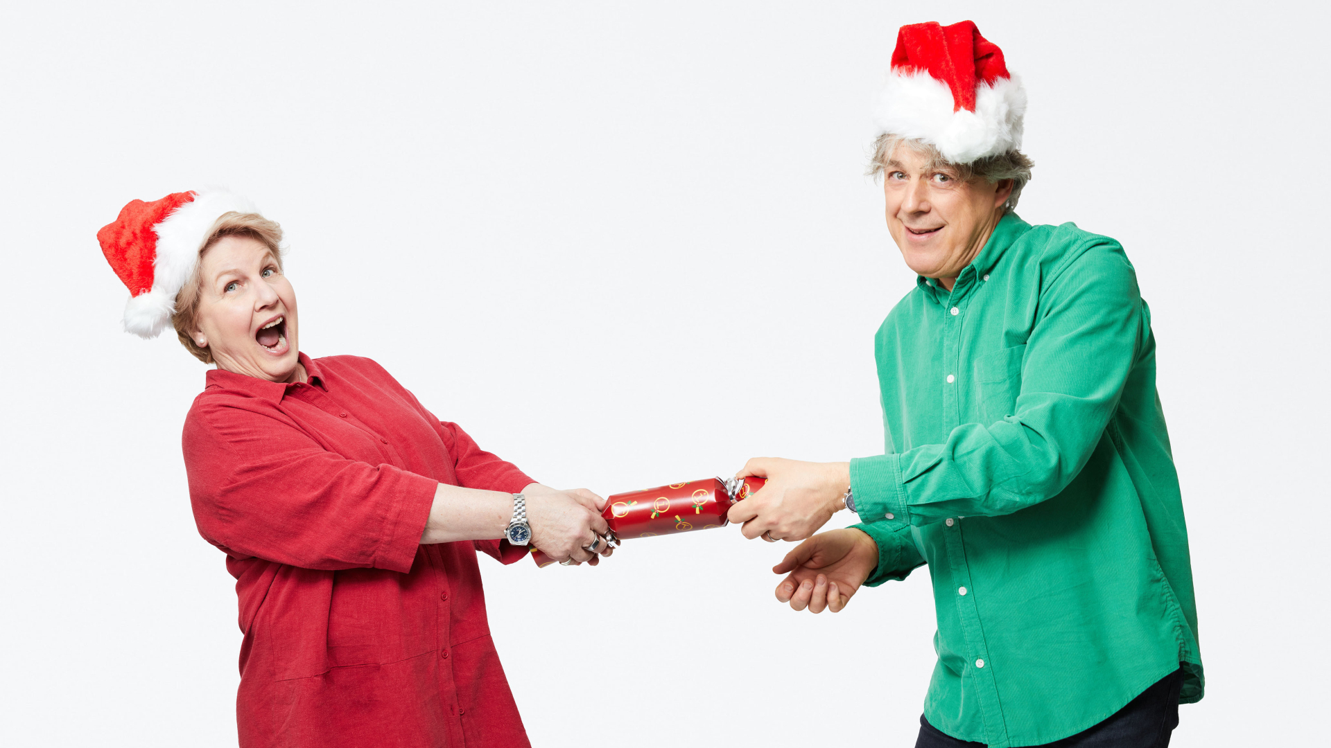 Sandi Toksvig and Alan Davies sharing a Christmas cracker