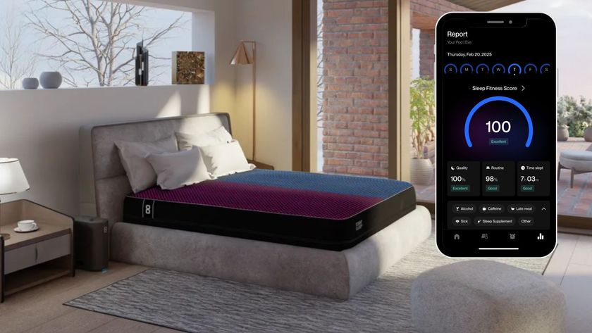 Eight Sleep Pod 4 mattress cover with dual temperature control (indicated by one side of the bed red and the other blue) in bedroom with floor to ceiling windows and a phone icon showing sleep report with 100 sleep score