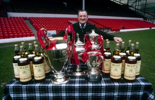 Liverpool manager Bob Paisley poses with the trophies won with the Reds in the 1980/81 season.