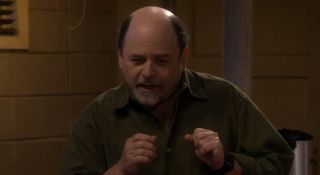 pastor phil pretending to talk into a microphone on the conners