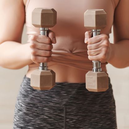 Slow weighted workouts: A woman doing an arm workout