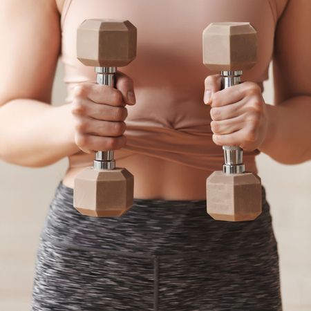 Slow weighted workouts: A woman doing an arm workout