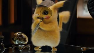 Detective Pikachu holds a magnifying glass to his eye in Pokémon Detective Pikachu.