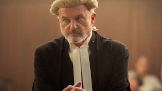 Sam Neill as Brett Colby QC in a courtroom setting in "The Twelve"