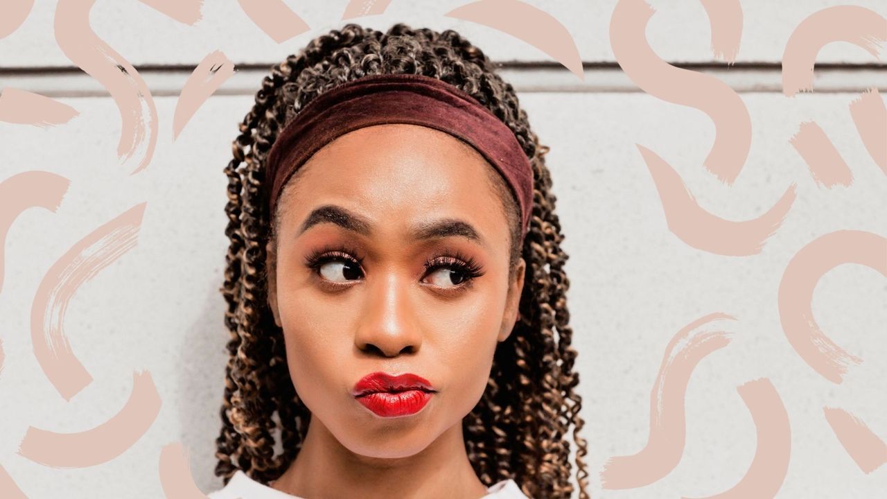 A woman with spring twist hair wearing red lipstick on a white backdrop