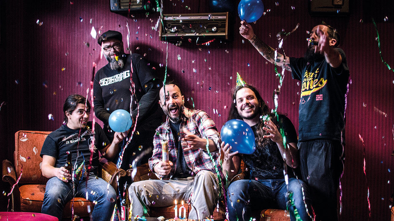 A press shot of Tardive Dyskinesia with balloons, confetti, streamers and party hats