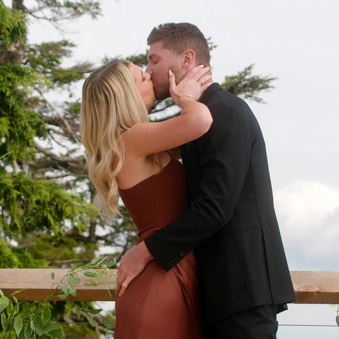 libby and andrew kiss each other on a balcony in the commitment ceremony of age of attraction