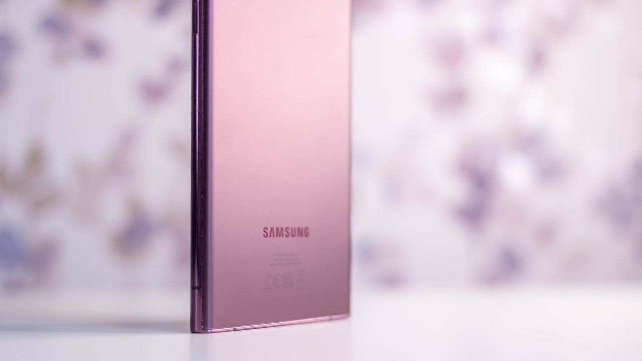 A photograph of the rear of the Samsung Galaxy S22 Ultra stood up on a table