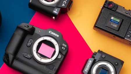 A selection of cameras on a colourful background