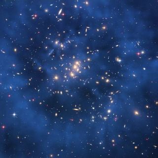The Hubble Space Telescope captured this image of galaxy cluster ZwCl0024+1652, revealing a ghostly ring of dark matter floating within the cluster. Astronomers said the ring, which measures 2.6 million light-years across, may have been produced by a coll