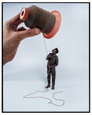Person with giant spool of thread