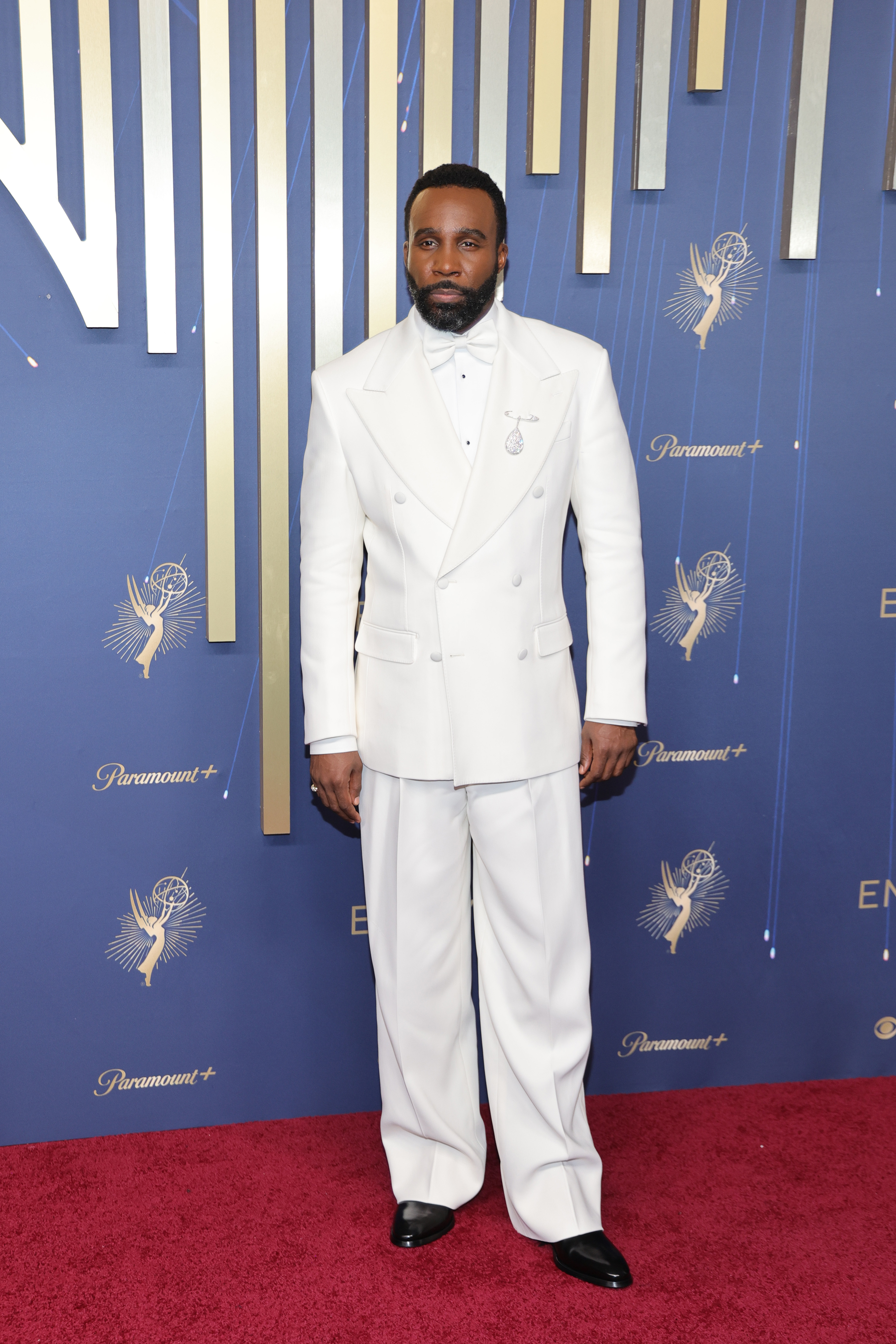 tramell tillman wears a white suit on the red carpet for the 2025 emmy awards