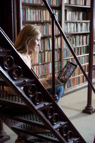 Female student uses laptop computer in library