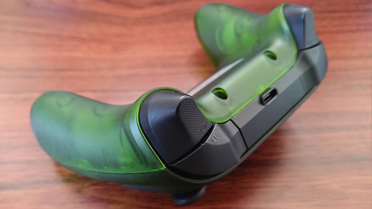Back angled view of Retro Fighters Hunter triggers and USB-C port on woodgrain desk.