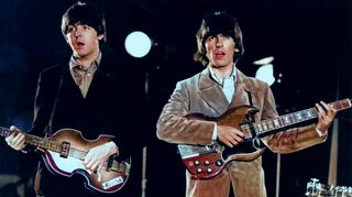 Paul McCartney and George Harrison mime for a video in 1966