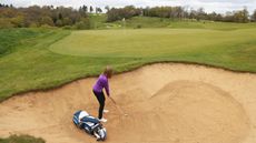A player places a bag down in a bunker