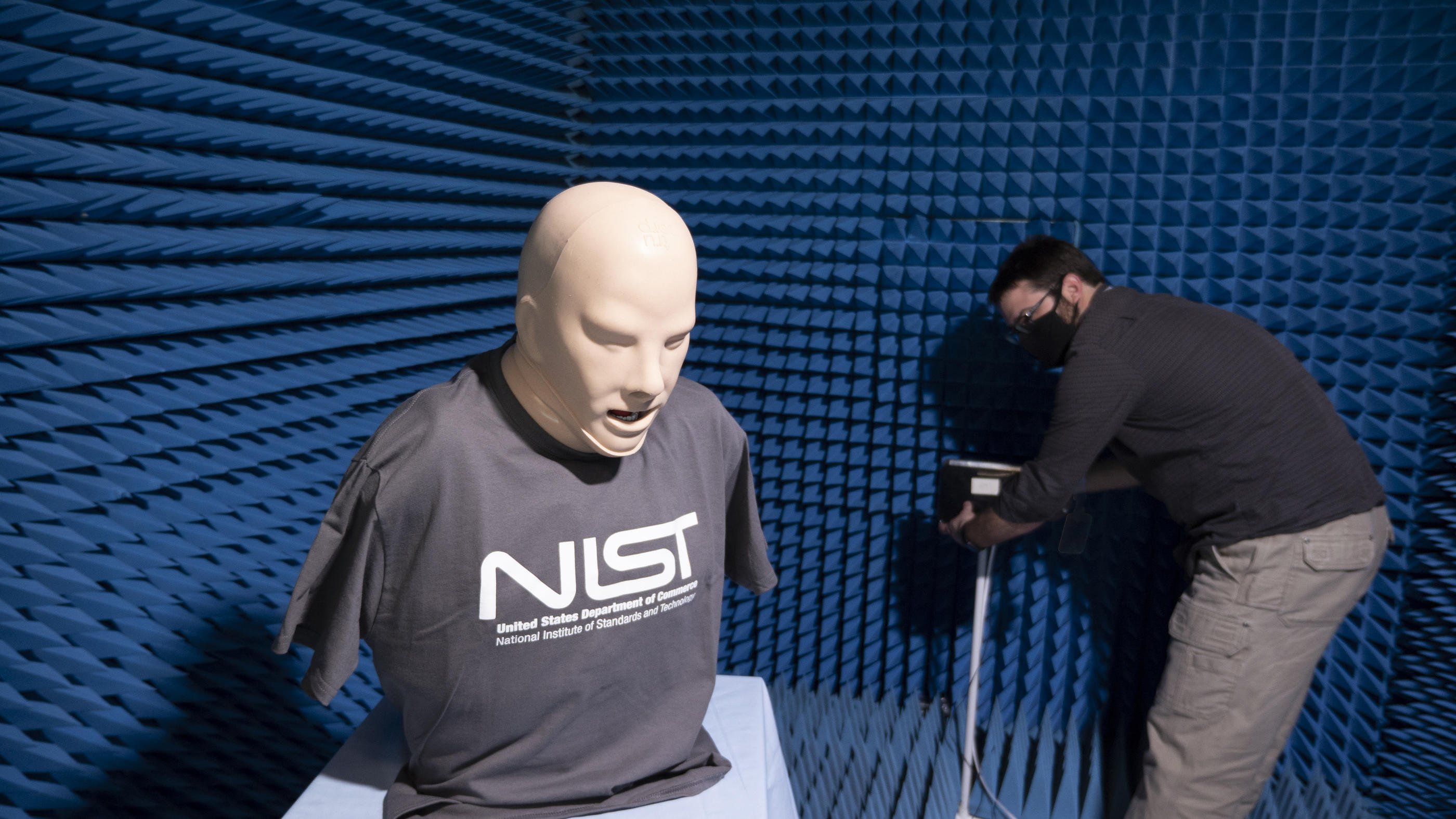 A breathing manikin being tested next to a Wi-Fi router in an anechoic chamber
