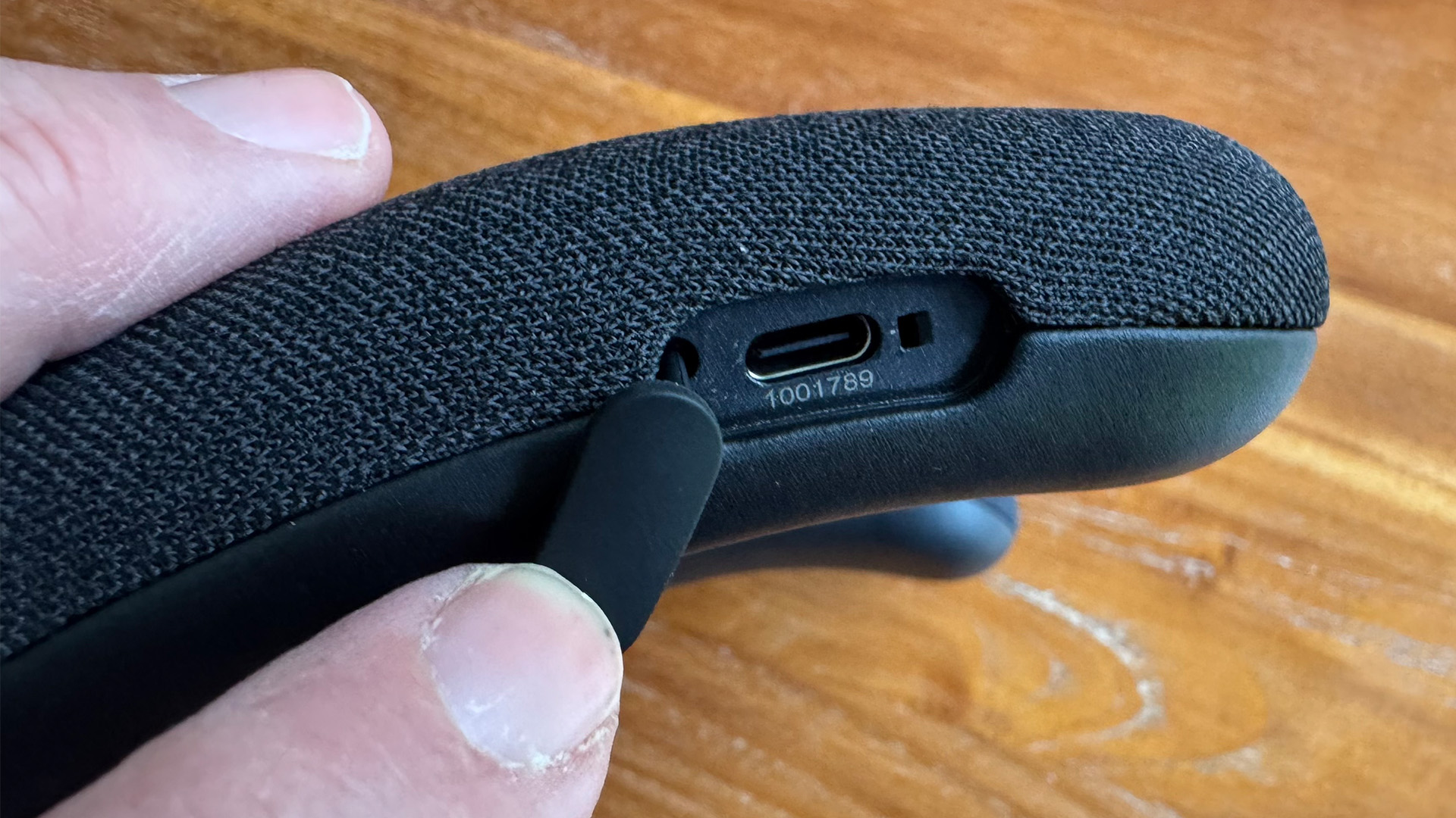Sony Bravia Theatre U personal audio system held between thumb and forefinger showing USB connection