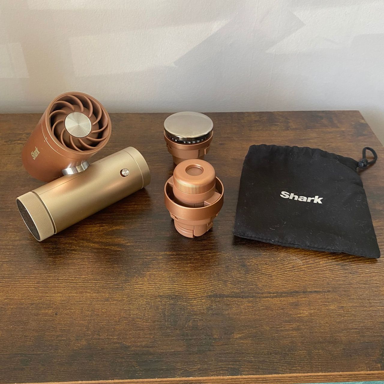 Shark ChillPill, misting pod, InstaChill cooling plate and storage pouch on a wooden surface