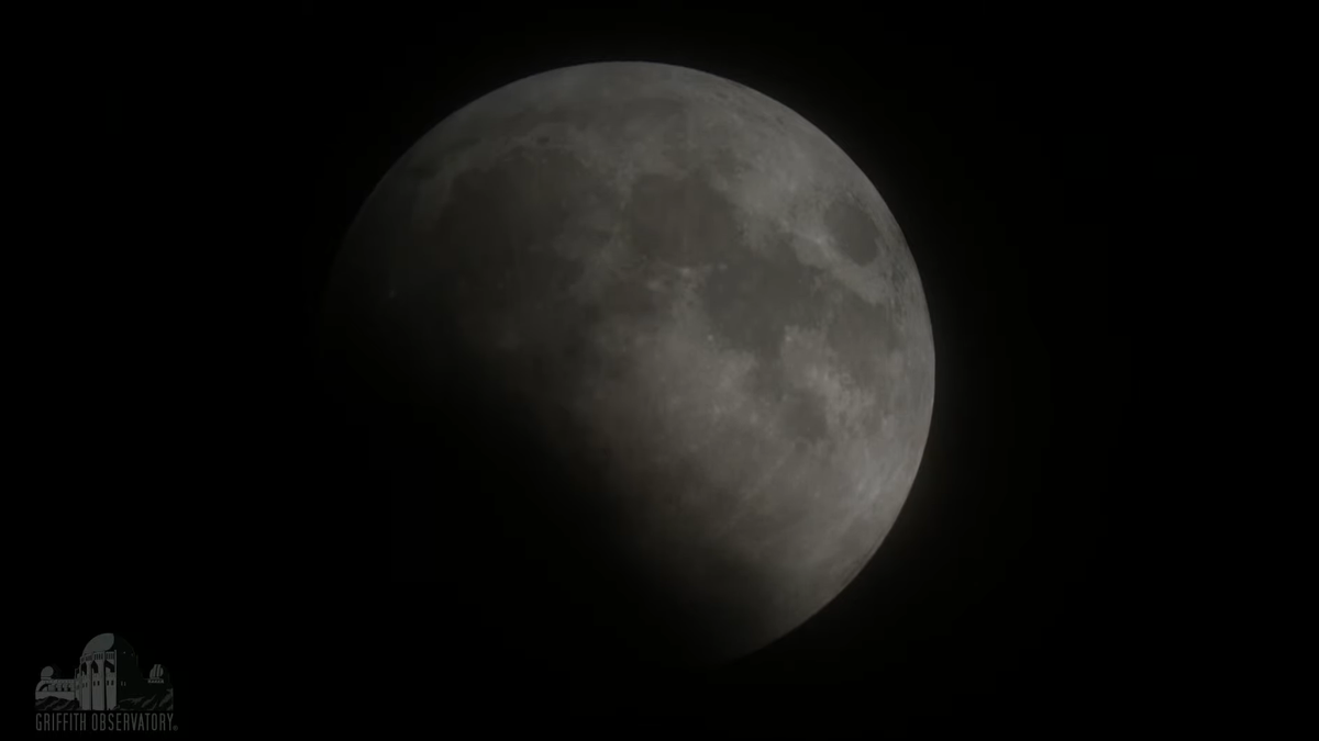 A view of the moon, about half eclipsed, on May 26, 2021, as seen from Griffith Observatory near Los Angeles.