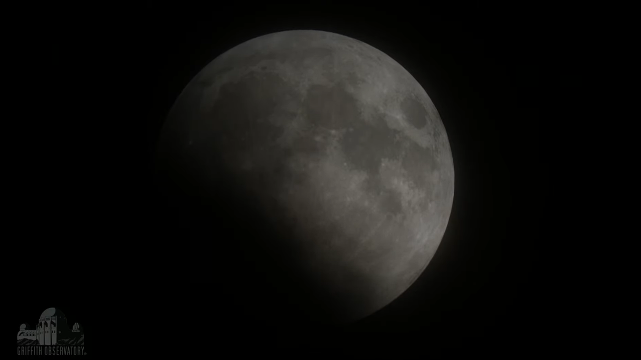 A view of the moon, about half eclipsed, on May 26, 2021, as seen from Griffith Observatory near Los Angeles.