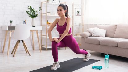 Woman doing a lunge while working out at home.
