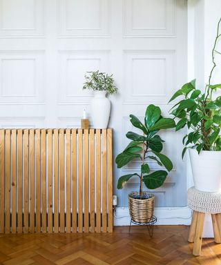 DIY wooden radiator cover over radiator in panelled wall living room