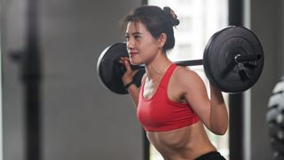 What is weight training? Image shows woman lifting weights