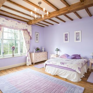 room with purple wall and wooden flooring
