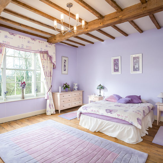 room with purple wall and wooden flooring