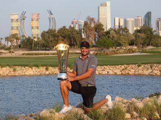 Peter Uihlein holding the international Series Qatar trophy