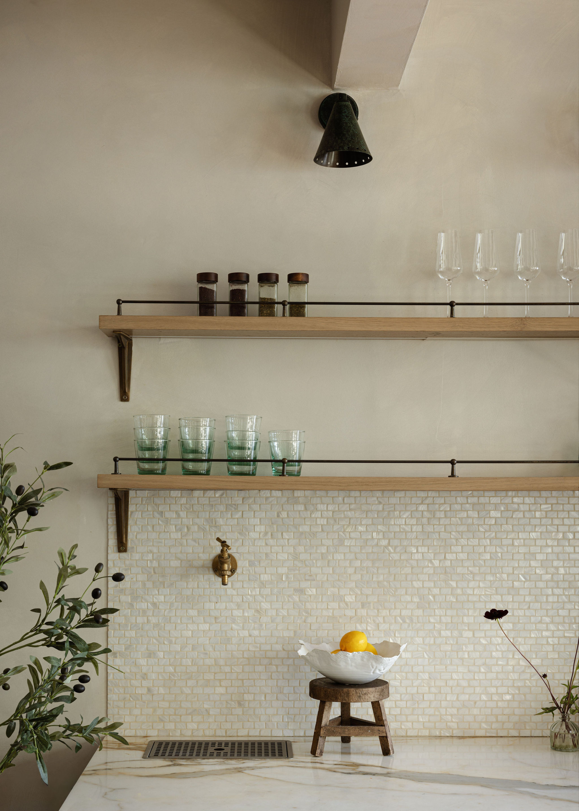 A pearl tiles backsplash alongside wooden wall-mounted storage shelves