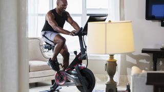 Man using exercise bike at home