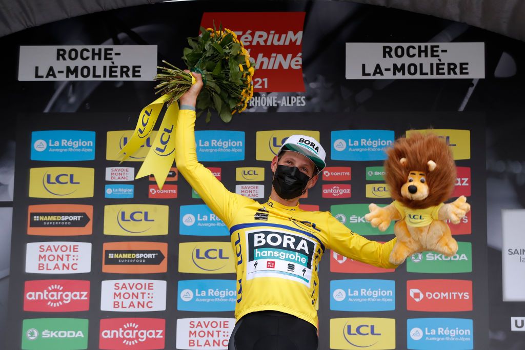 ROCHELAMOLIERE FRANCE JUNE 02 Lukas Pstlberger of Austria and Team Bora Hansgrohe Yellow Leader Jersey celebrates at podium during the 73rd Critrium du Dauphin 2021 Stage 4 a 164km Individual Time Trial stage from Firminy to RochelaMolire 585m Lion Mascot ITT UCIworldtour Dauphin dauphine on June 02 2021 in RochelaMoliere France Photo by Bas CzerwinskiGetty Images